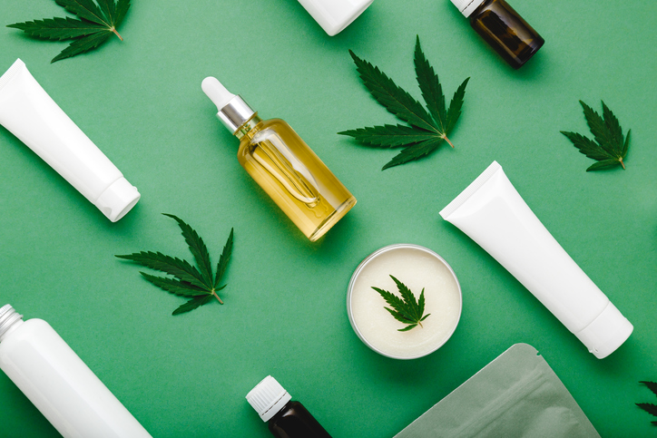 Hemp cbd oil serum in glass dropper bottle with cannabis leaves, Moisturizing cream, Serum, lotion, essential oil. Cannabis leaf with skincare cosmetic product Flat lay pattern on green background