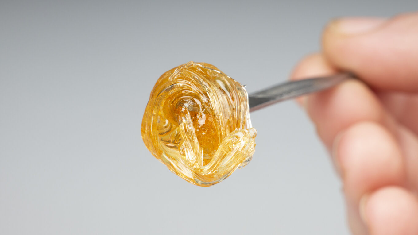 yellow resin extract on dab stick tool closeup, gold wax smear for stoner smoke badder wax